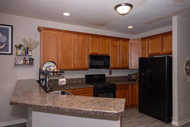 105 Autumn Ter SW, Etna, OH 43062 - kitchen with a sink, baseboards, black appliances, a peninsula, and light wood-style floors