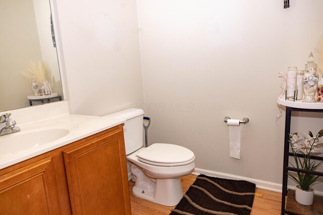 105 Autumn Ter SW, Etna, OH 43062 - half bath featuring toilet, baseboards, wood finished floors, and vanity
