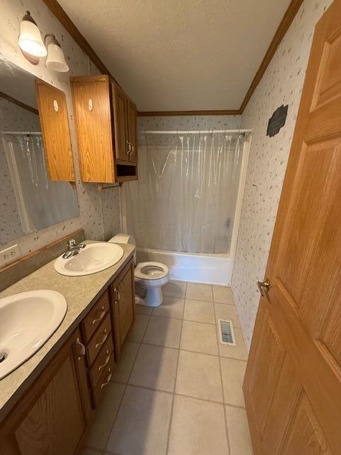 bathroom with ornamental molding, visible vents, and wallpapered walls