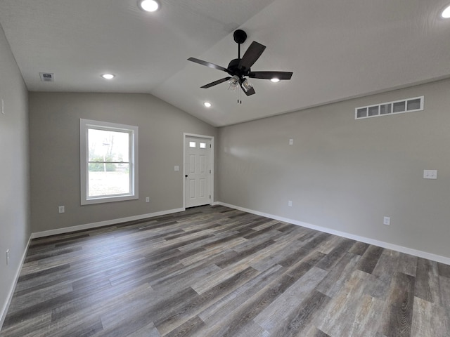 spare room with ceiling fan, baseboards, wood finished floors, vaulted ceiling, and visible vents