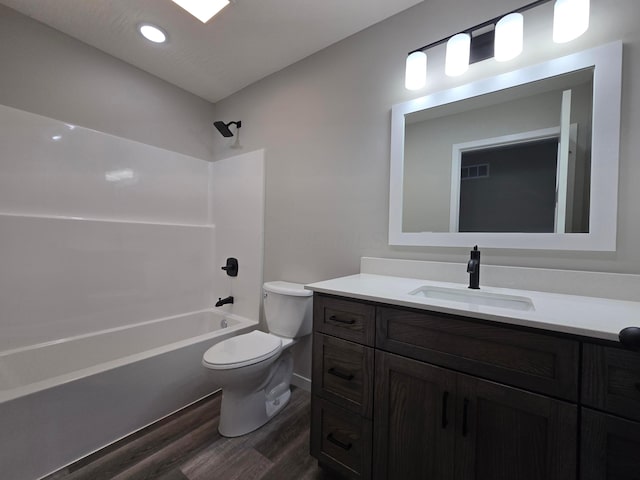 full bath featuring vanity, bathtub / shower combination, toilet, wood finished floors, and visible vents