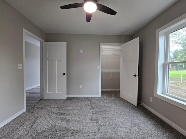 unfurnished bedroom with carpet floors, baseboards, and a closet