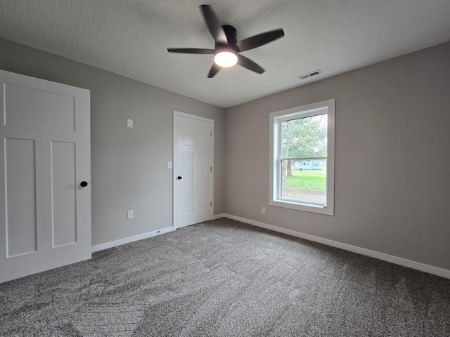 unfurnished bedroom featuring visible vents, carpet flooring, and baseboards
