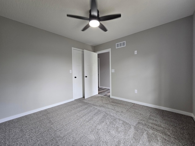 unfurnished bedroom with carpet floors, a ceiling fan, baseboards, visible vents, and a closet