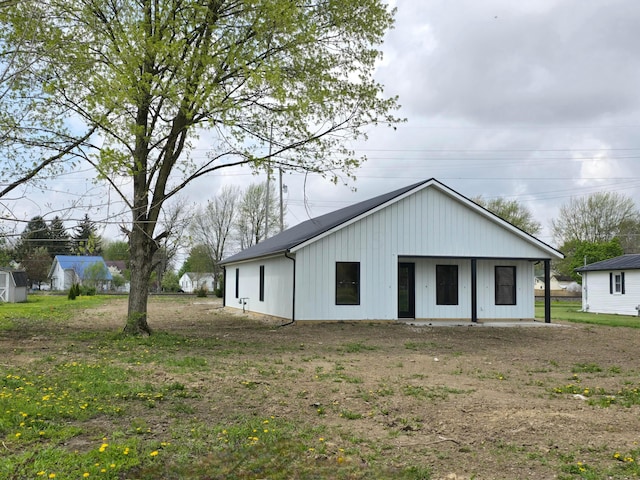 rear view of property featuring board and batten siding