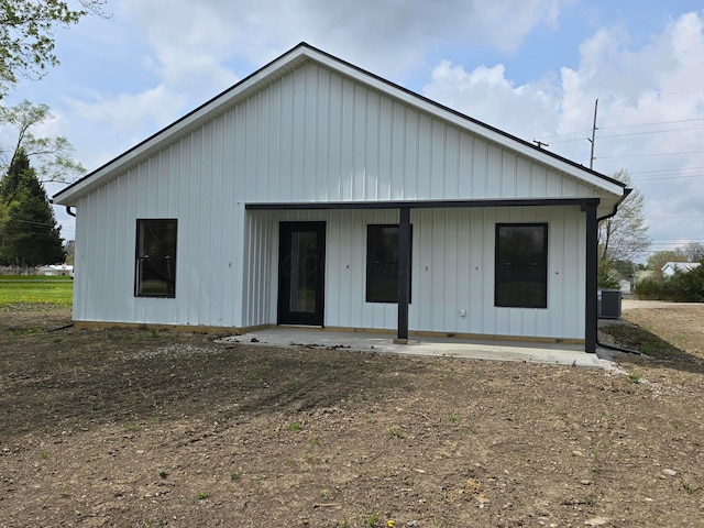 rear view of house featuring cooling unit