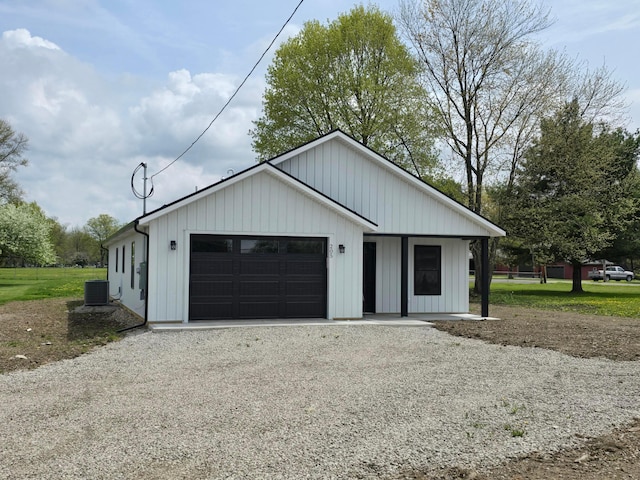 garage featuring driveway and central AC unit