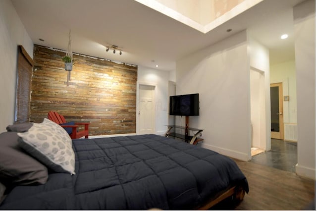 1033 Franklin Ave, Columbus, OH 43205 - bedroom featuring baseboards, wood walls, recessed lighting, wood finished floors, and rail lighting