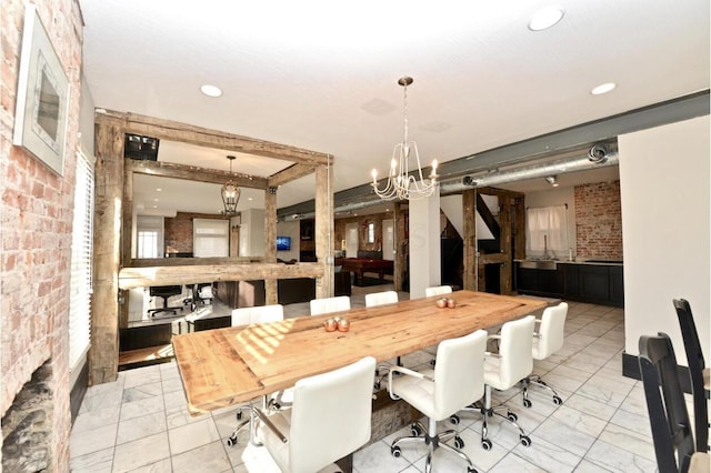 1033 Franklin Ave, Columbus, OH 43205 - dining room with brick wall, a chandelier, and recessed lighting