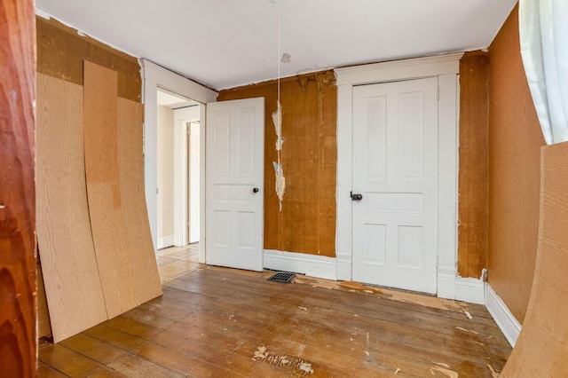 spare room with hardwood / wood-style floors