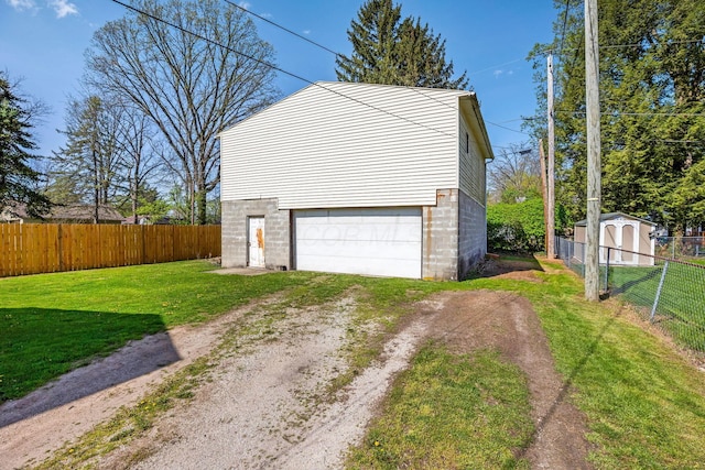 garage with fence and dirt driveway
