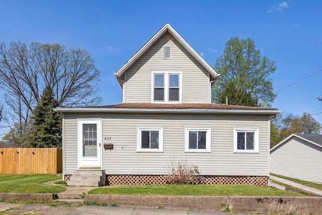back of property featuring a lawn, entry steps, and fence
