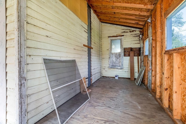 interior space featuring wood walls and lofted ceiling