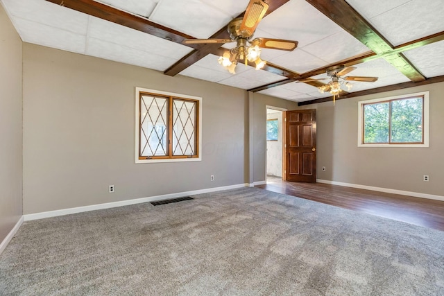 carpeted spare room featuring coffered ceiling, visible vents, ceiling fan, and baseboards