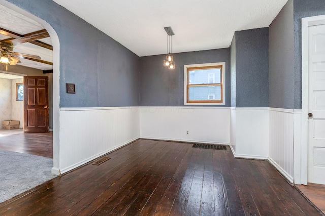 unfurnished dining area with plenty of natural light, hardwood / wood-style floors, and wainscoting