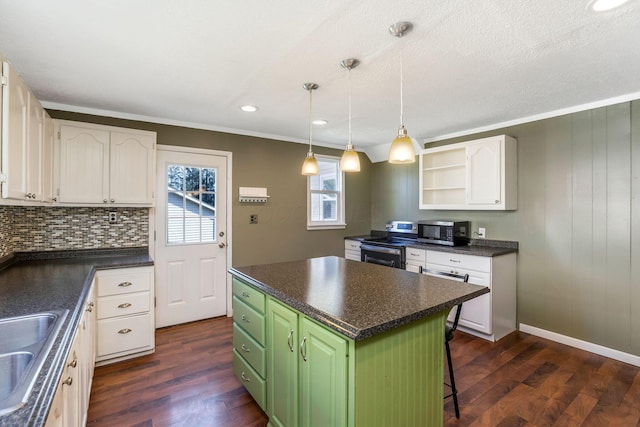 kitchen featuring dark countertops, stainless steel appliances, and white cabinets