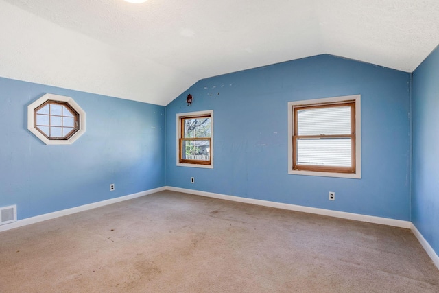 bonus room featuring baseboards, visible vents, carpet, and lofted ceiling