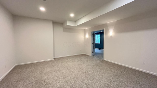 below grade area with recessed lighting, baseboards, and light carpet