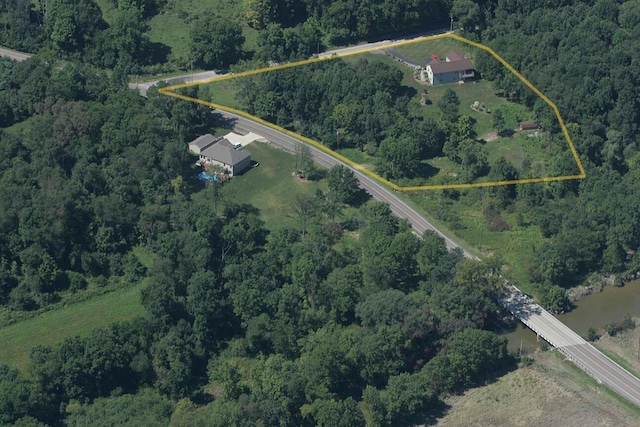 drone / aerial view featuring a wooded view