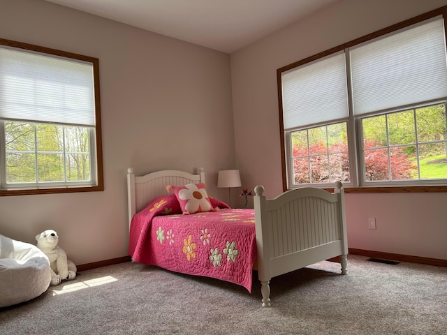 carpeted bedroom featuring visible vents and baseboards