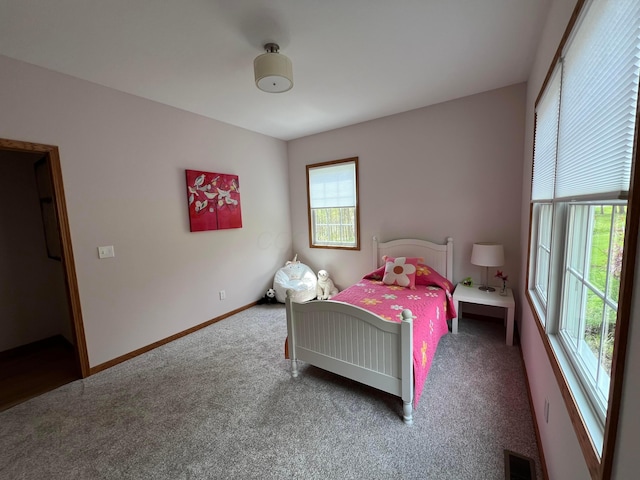 bedroom with baseboards, carpet flooring, and visible vents