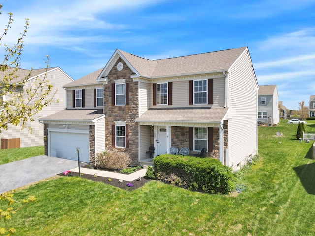 traditional home with a front yard, a shingled roof, driveway, stone siding, and an attached garage
