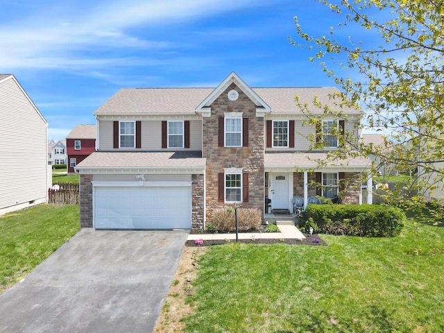 traditional-style house featuring a garage, concrete driveway, a front yard, and stone siding