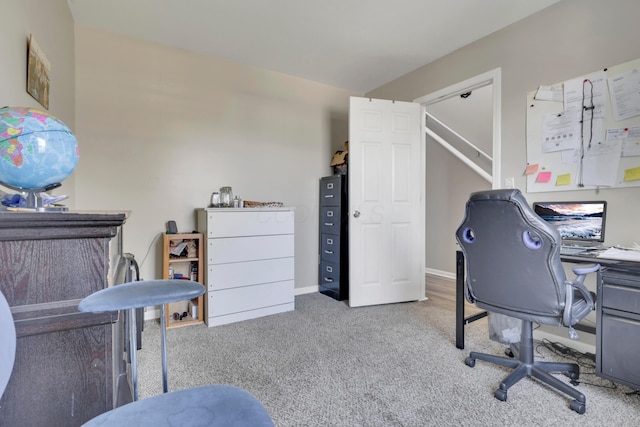 carpeted office space featuring baseboards