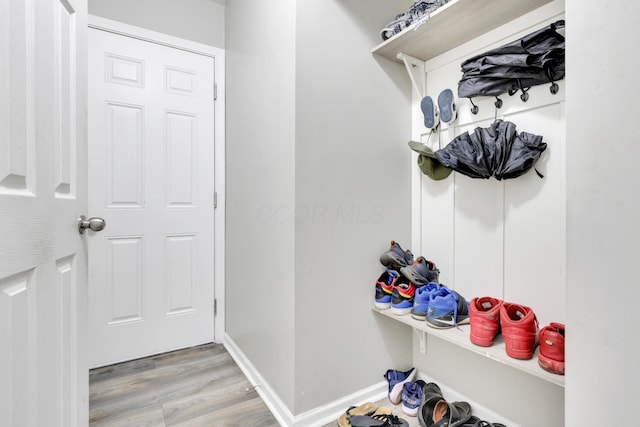 mudroom with light wood-style flooring and baseboards