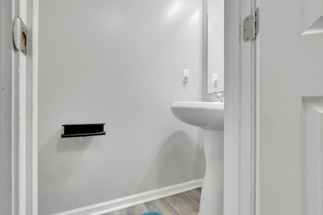 bathroom featuring wood finished floors and baseboards