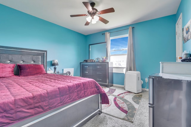 bedroom featuring baseboards, light carpet, ceiling fan, and freestanding refrigerator