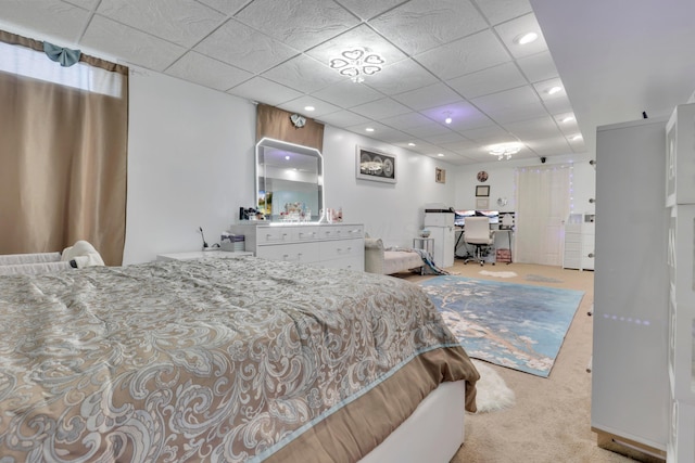carpeted bedroom with recessed lighting and a drop ceiling