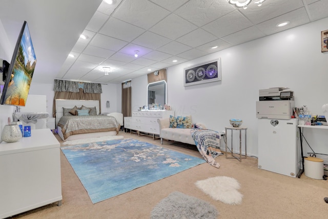 carpeted bedroom featuring a paneled ceiling and recessed lighting