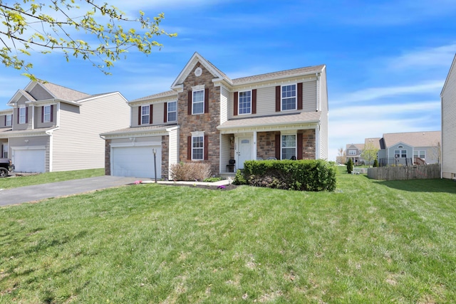 traditional-style home featuring a front lawn, stone siding, aphalt driveway, an attached garage, and fence