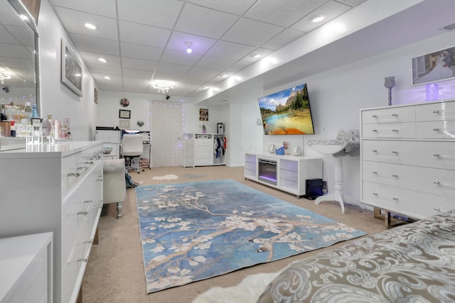 interior space featuring a drop ceiling and light carpet