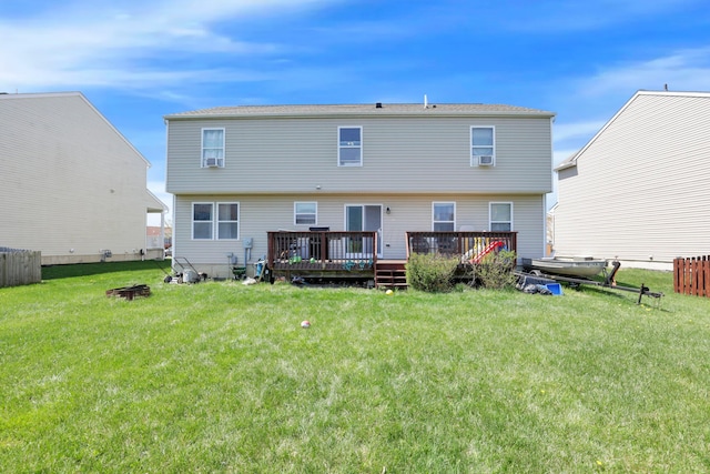 rear view of house with a wooden deck and a yard