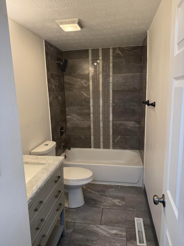 bathroom featuring visible vents, toilet, a textured ceiling, and bathtub / shower combination