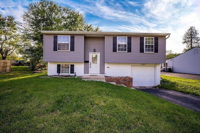 2987 Olivette Rd, Columbus, OH 43232 - split foyer home featuring asphalt driveway, an attached garage, and a front lawn