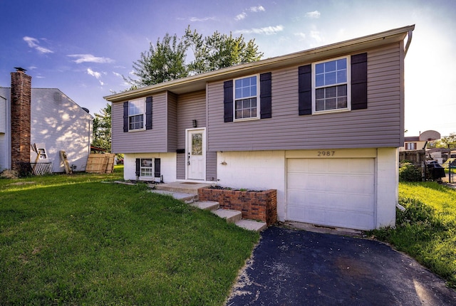 2987 Olivette Rd, Columbus, OH 43232 - bi-level home with an attached garage and driveway