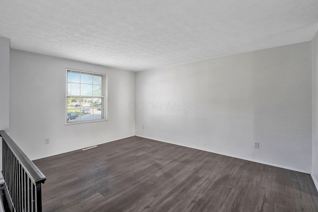 2987 Olivette Rd, Columbus, OH 43232 - spare room with dark wood finished floors and a textured ceiling