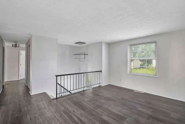 2987 Olivette Rd, Columbus, OH 43232 - unfurnished room with dark wood-style flooring and a textured ceiling