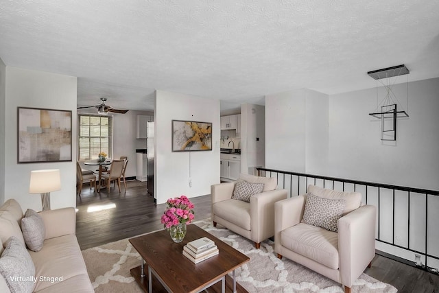 2987 Olivette Rd, Columbus, OH 43232 - living area featuring dark wood-type flooring, a ceiling fan, and a textured ceiling