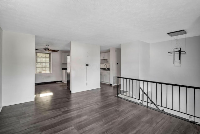 2987 Olivette Rd, Columbus, OH 43232 - empty room with dark wood-type flooring, a textured ceiling, ceiling fan, and baseboards