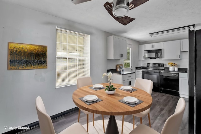 2987 Olivette Rd, Columbus, OH 43232 - dining room featuring a ceiling fan, dark wood-style flooring, and baseboards