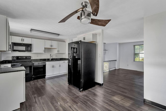 2987 Olivette Rd, Columbus, OH 43232 - kitchen featuring black appliances, a sink, ceiling fan, dark countertops, and white cabinetry