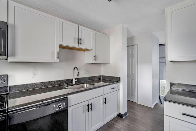 2987 Olivette Rd, Columbus, OH 43232 - kitchen with a sink, black dishwasher, dark wood finished floors, white cabinets, and dark stone counters