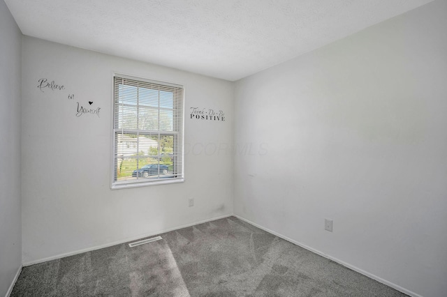 2987 Olivette Rd, Columbus, OH 43232 - unfurnished room with carpet floors, baseboards, and a textured ceiling