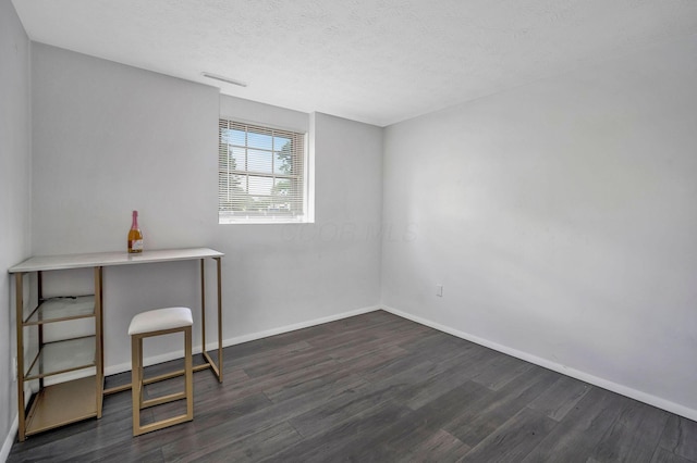 2987 Olivette Rd, Columbus, OH 43232 - unfurnished office with dark wood-style flooring, baseboards, and a textured ceiling