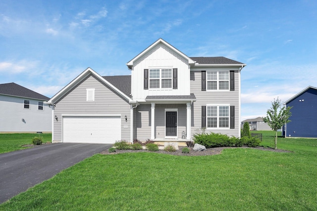 traditional-style home featuring board and batten siding, driveway, and a front yard