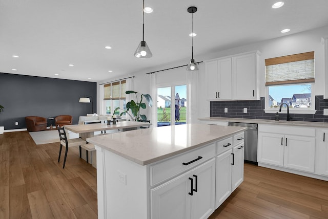 kitchen with recessed lighting, a sink, light wood-style flooring, and dishwasher